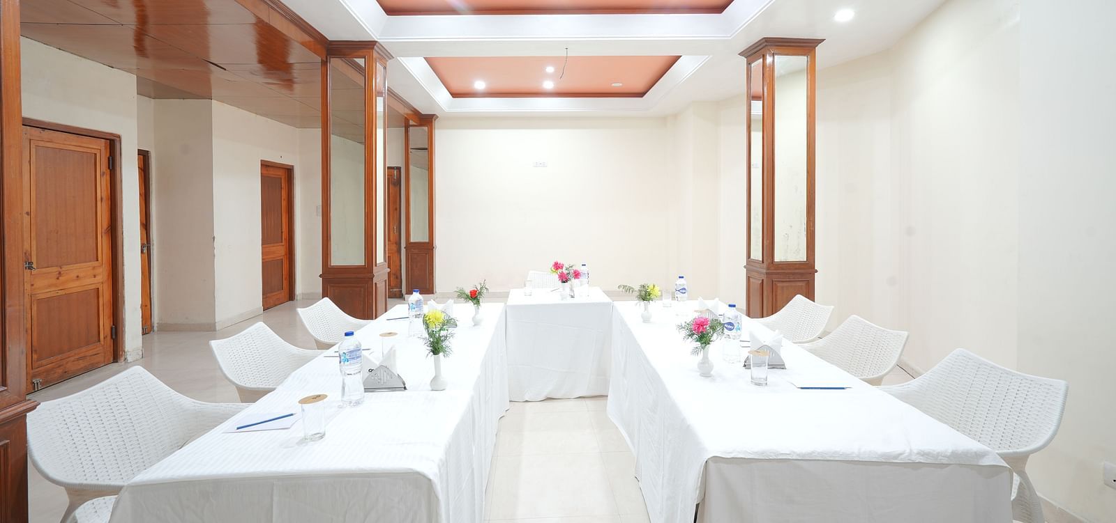 Conference hall with chairs and tables neatly arranged at DLS Hotels The Rock Castle.